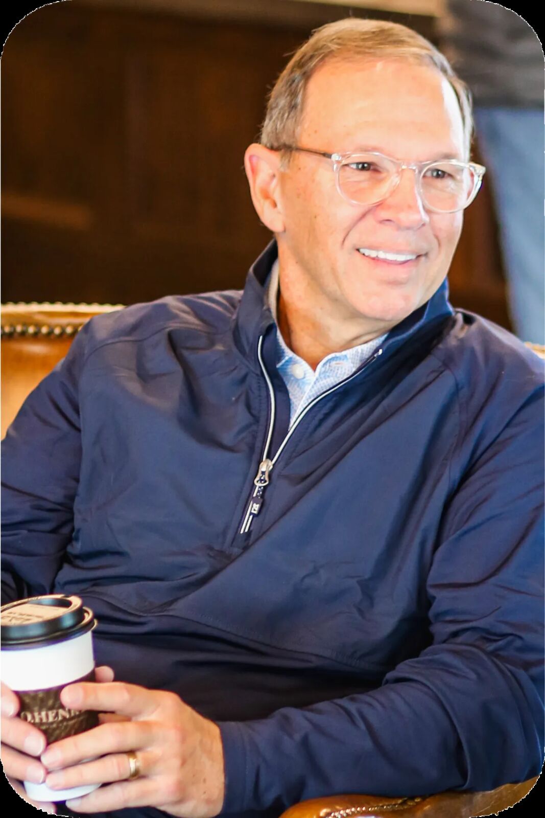 Rex Davis smiling with a cup of coffee